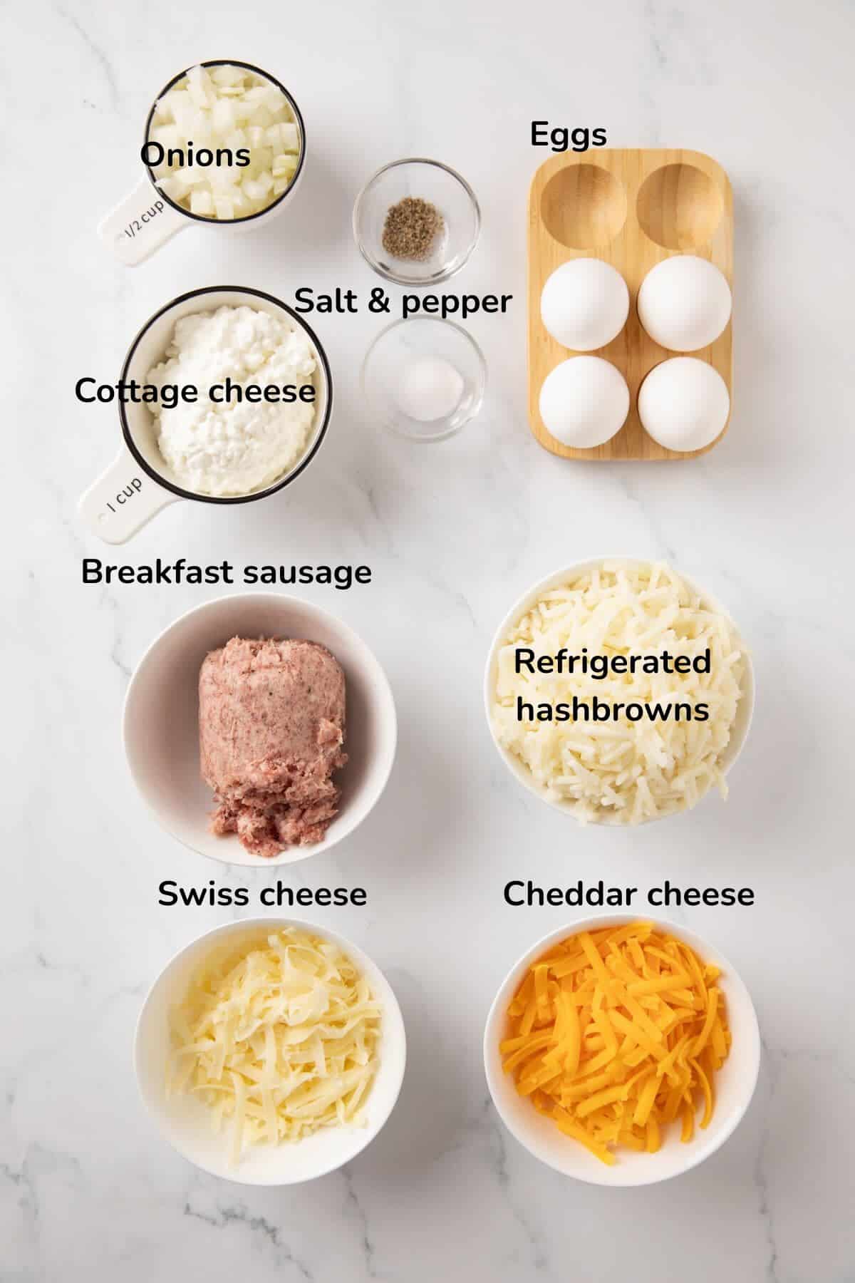 Ingredients to make sausage egg bites, includes breakfast sausage, hash browns, cottage cheese, cheddar cheese and eggs.