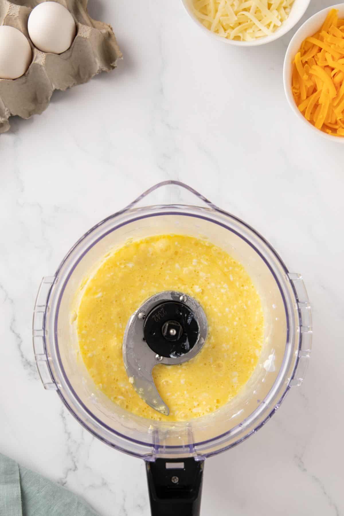 Eggs and cottage cheese in a food processor.
