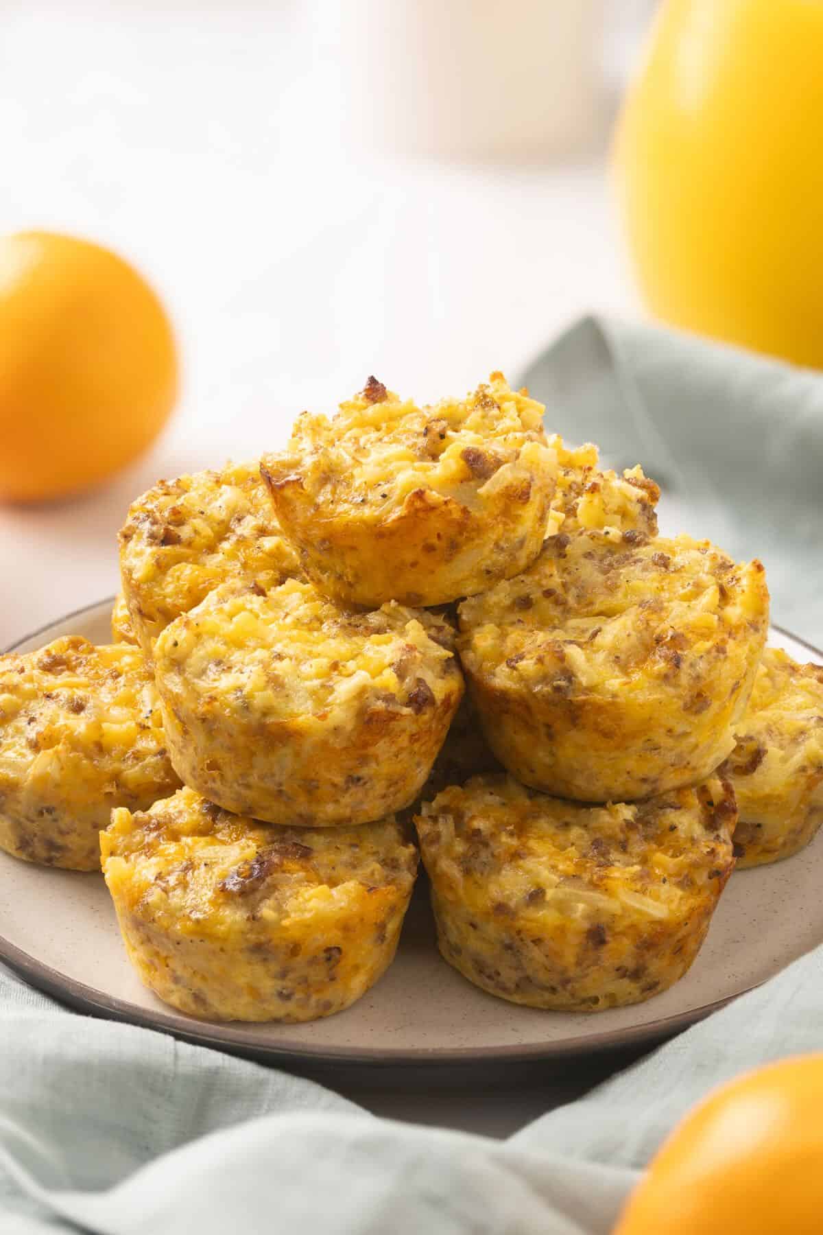 A dozen sausage egg bites stacked on a plate ready to serve. 