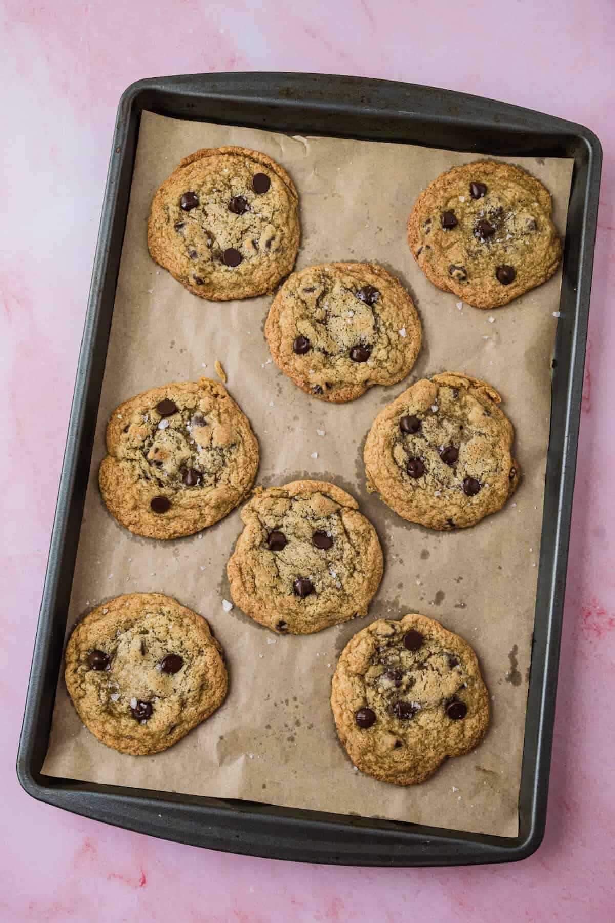 Baked small batch chocolate chip cookies on a baking sheet.