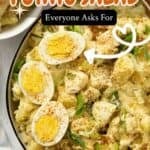 Deviled Egg Potato Salad garnished with paprika, sliced hard boiled eggs and and sliced scallions.