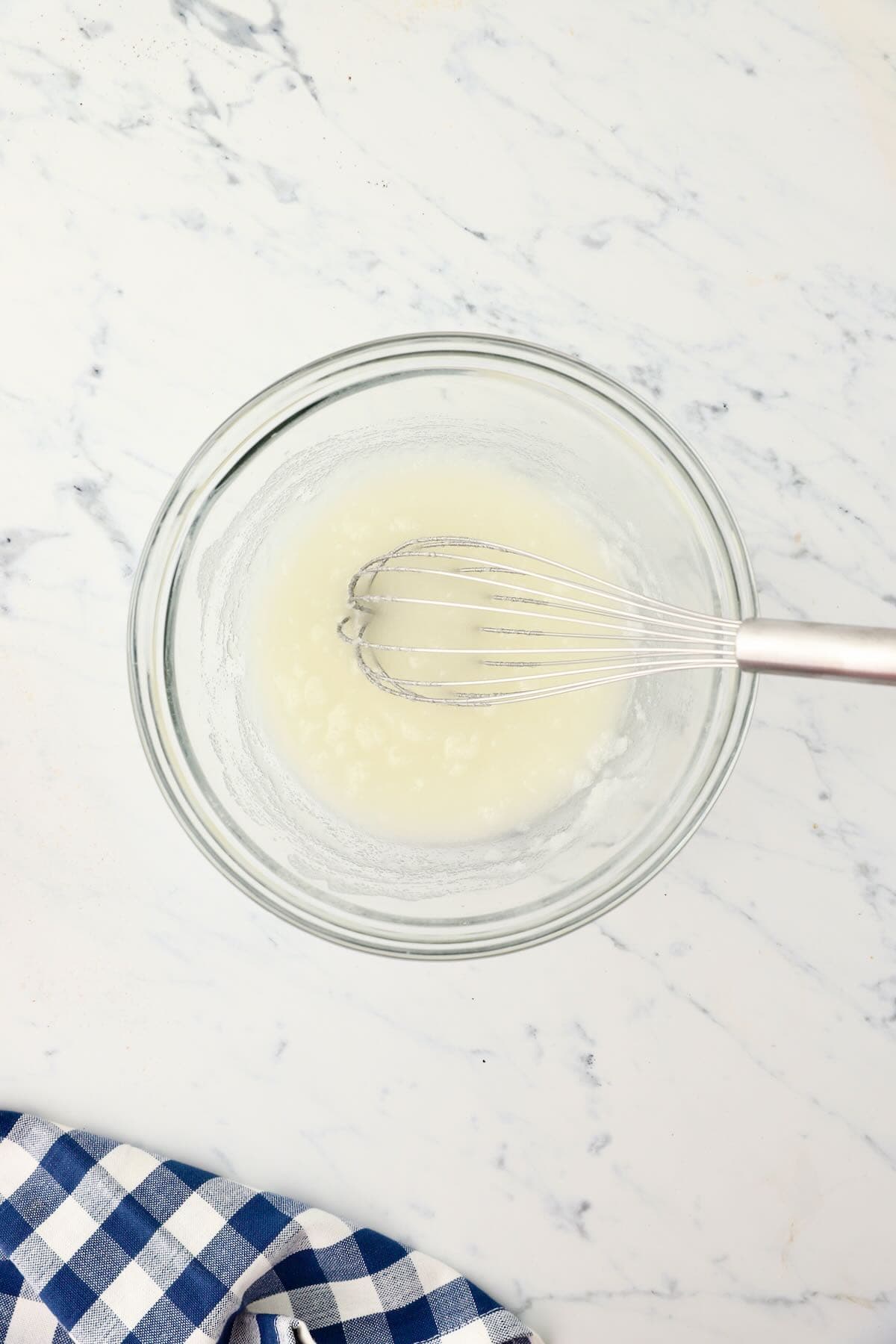 Mix oil and sugar in a glass mixing bowl.