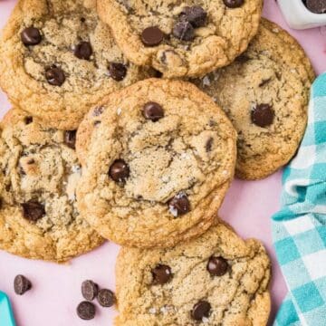 Chocolate chip cookies after baking topped with a sprinkle of sea salt.