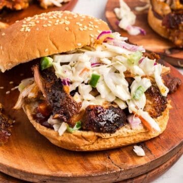 Air fried pulled pork piled high on a sesame seed bun with coleslaw.
