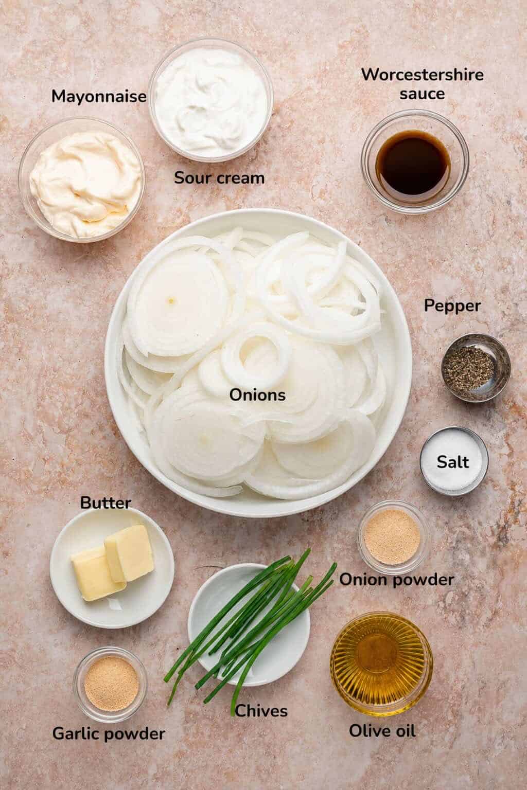 Ingredients for caramelized onion dip including sour cream, onions and seasonings.