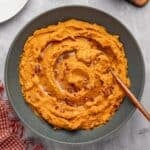 Savory mashed sweet potatoes topped with browned butter and roasted pecans.