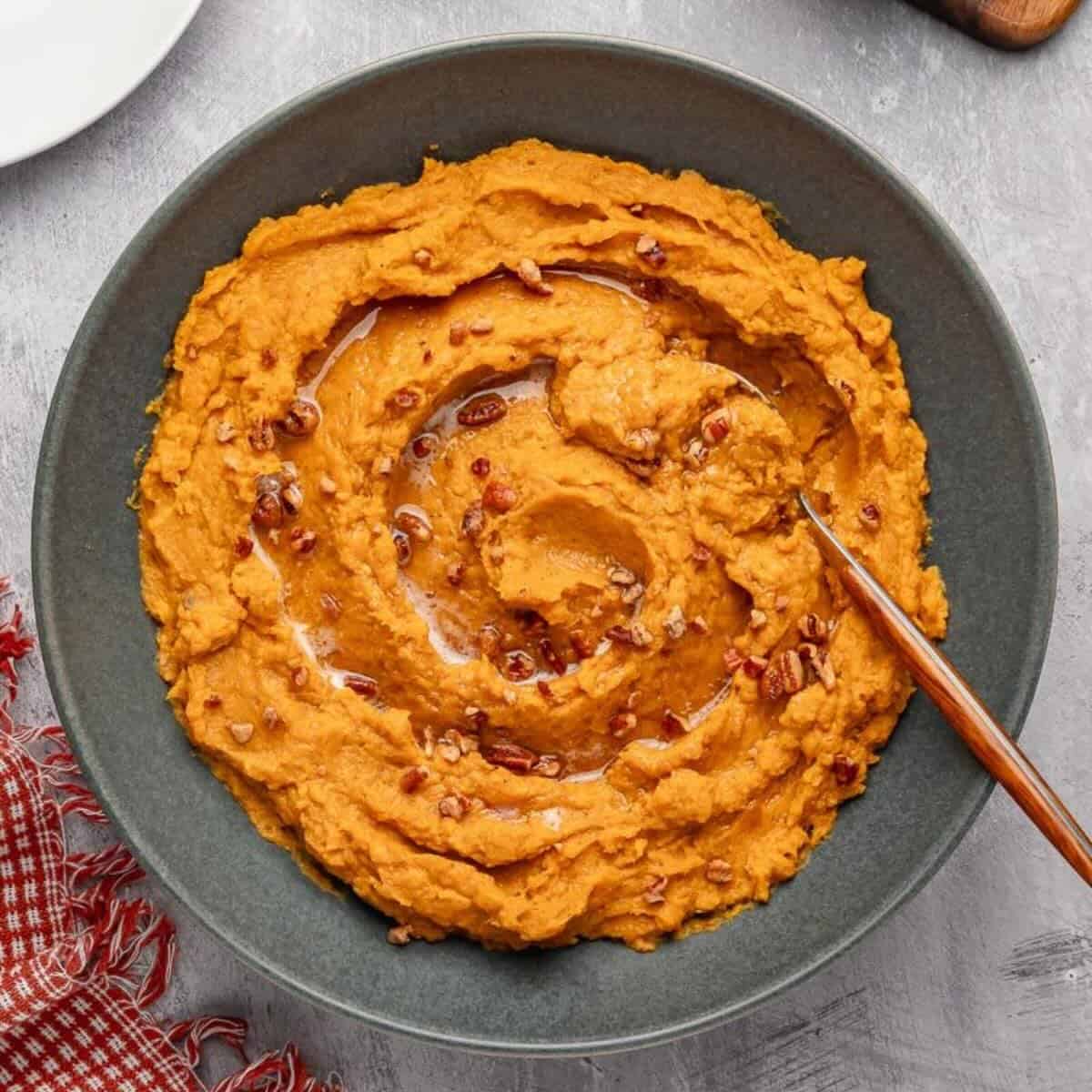 Savory mashed sweet potatoes topped with browned butter and roasted pecans.