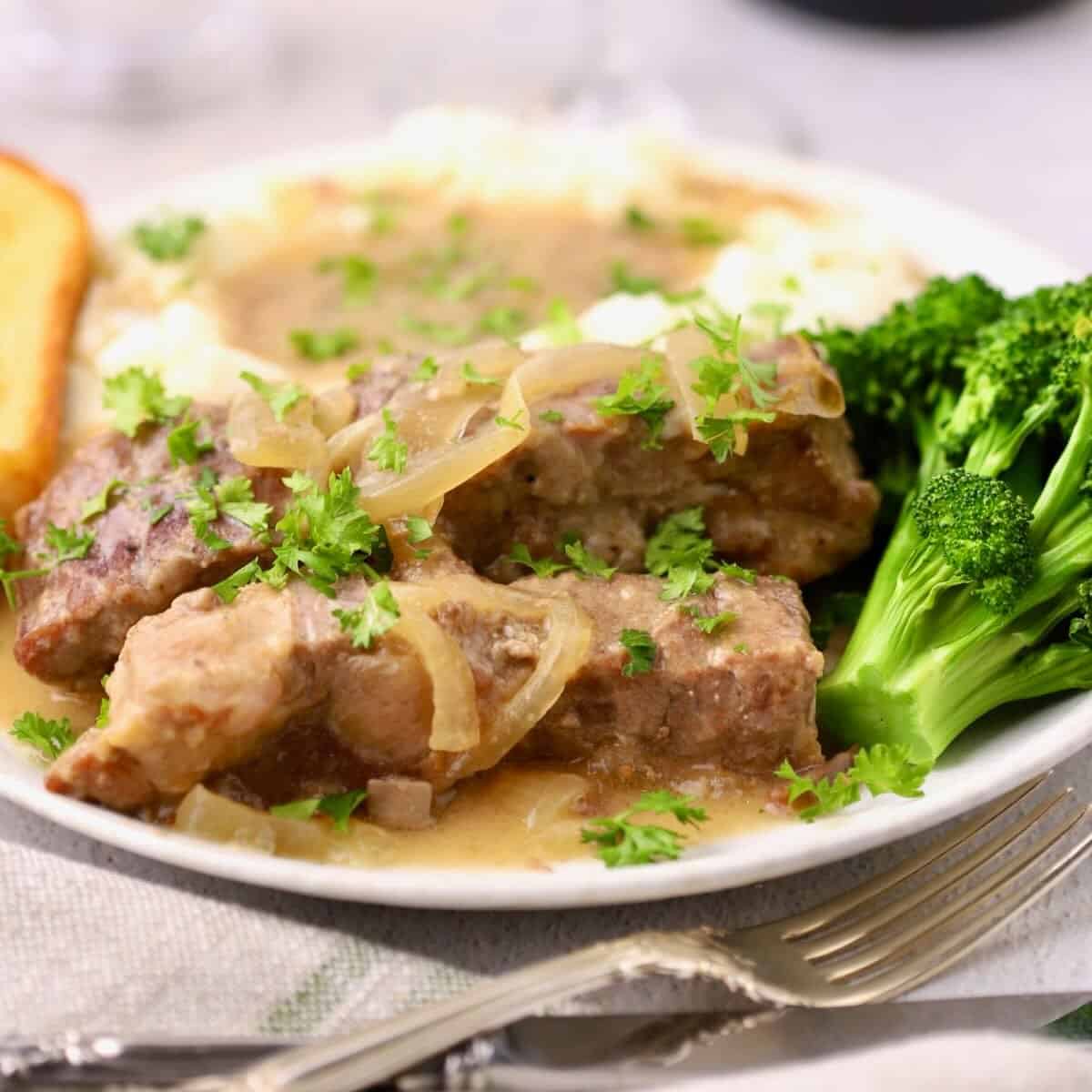 Slow cooker country style ribs with Vidalia onion gravy served over creamy mashed potatoes