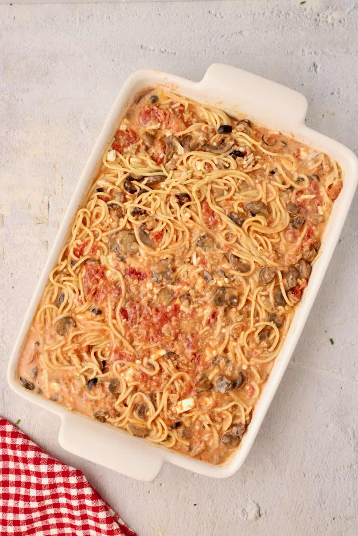A white baking dish full of spaghetti pie casserole.