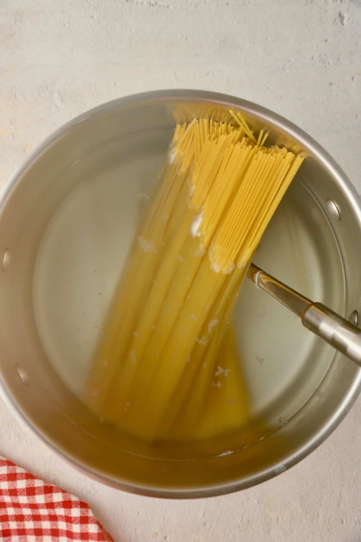 Cooking spaghetti in a large Dutch oven.
