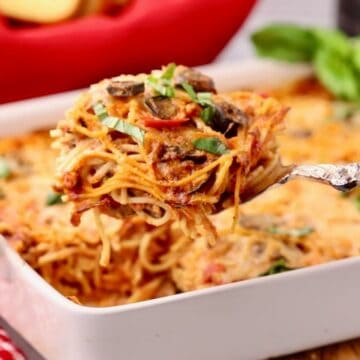 A large serving os spaghetti pie casserole and the baking dish.