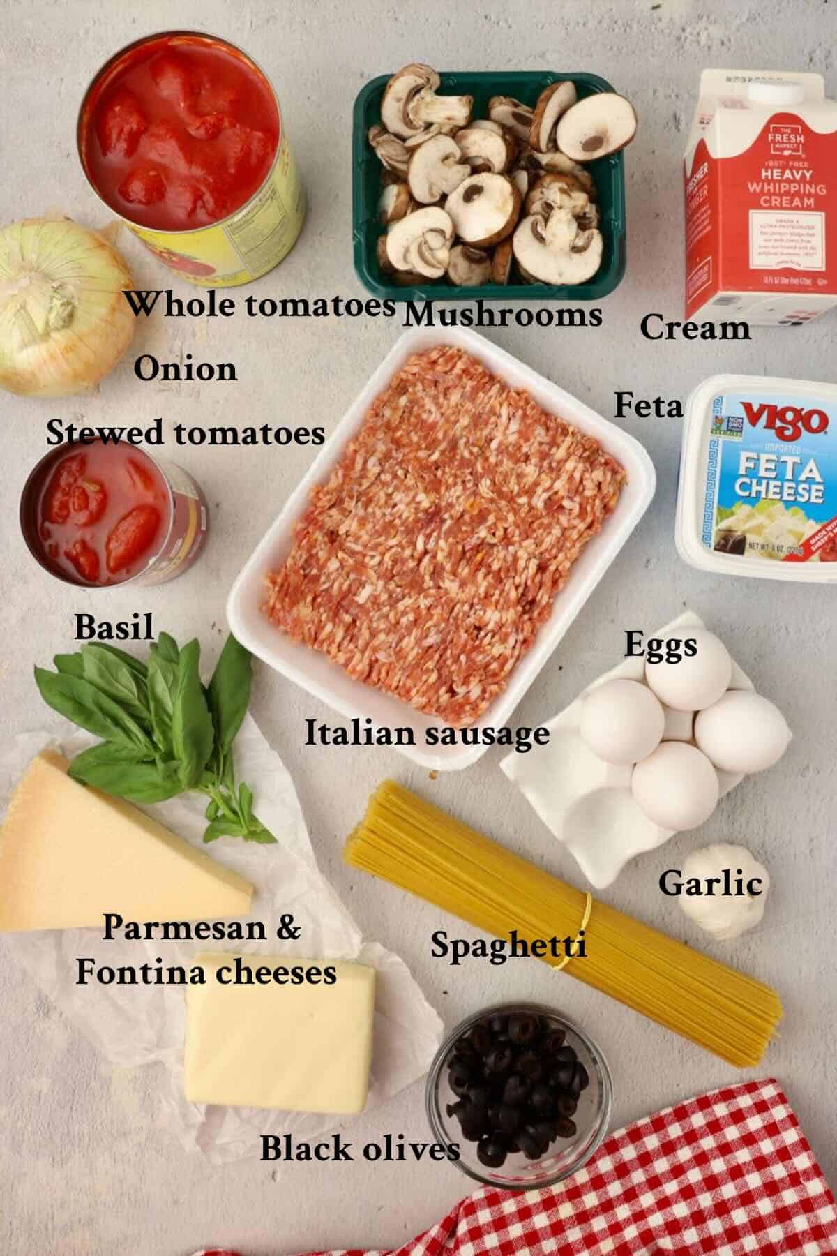 Ingredients for spaghetti pie casserole include Italian sausage, canned tomato sauces, eggs, cream, and cheeses.