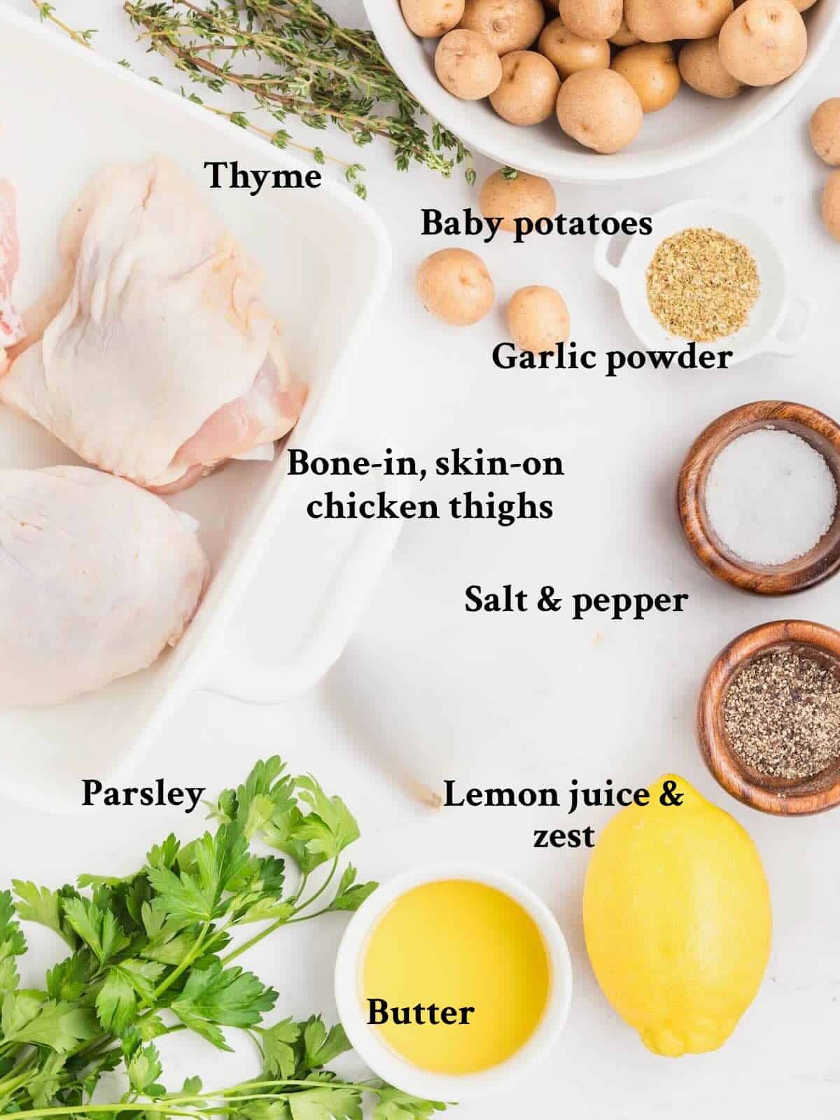 Ingredients for baked chicken thighs and potatoes include bone-in, skin-on chicken thighs and baby potatoes.