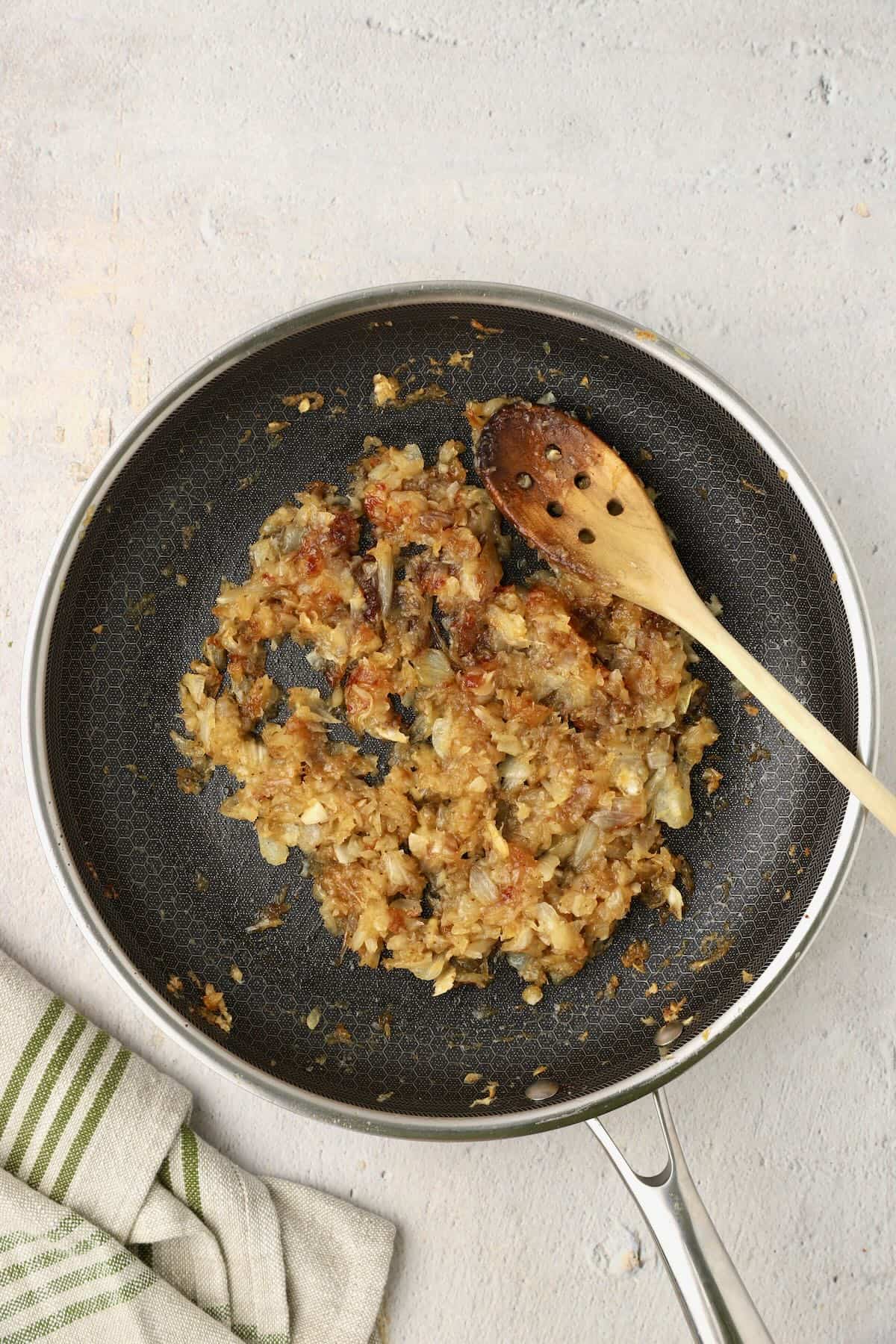 Caramelized onions in a skillet after 60 minutes. Deep golden brown and jammy.