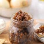 Bourbon bacon onion jam made with caramelized onions, crispy bacon, bourbon, and balsamic vinegar served in a glass jar.