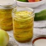 Jar of sweet pickled green tomatoes and Vidalia onions in refrigerator pickle brine.