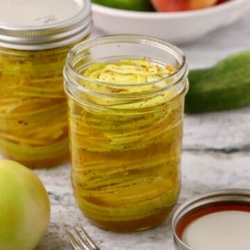 Jar of sweet pickled green tomatoes and Vidalia onions in refrigerator pickle brine.