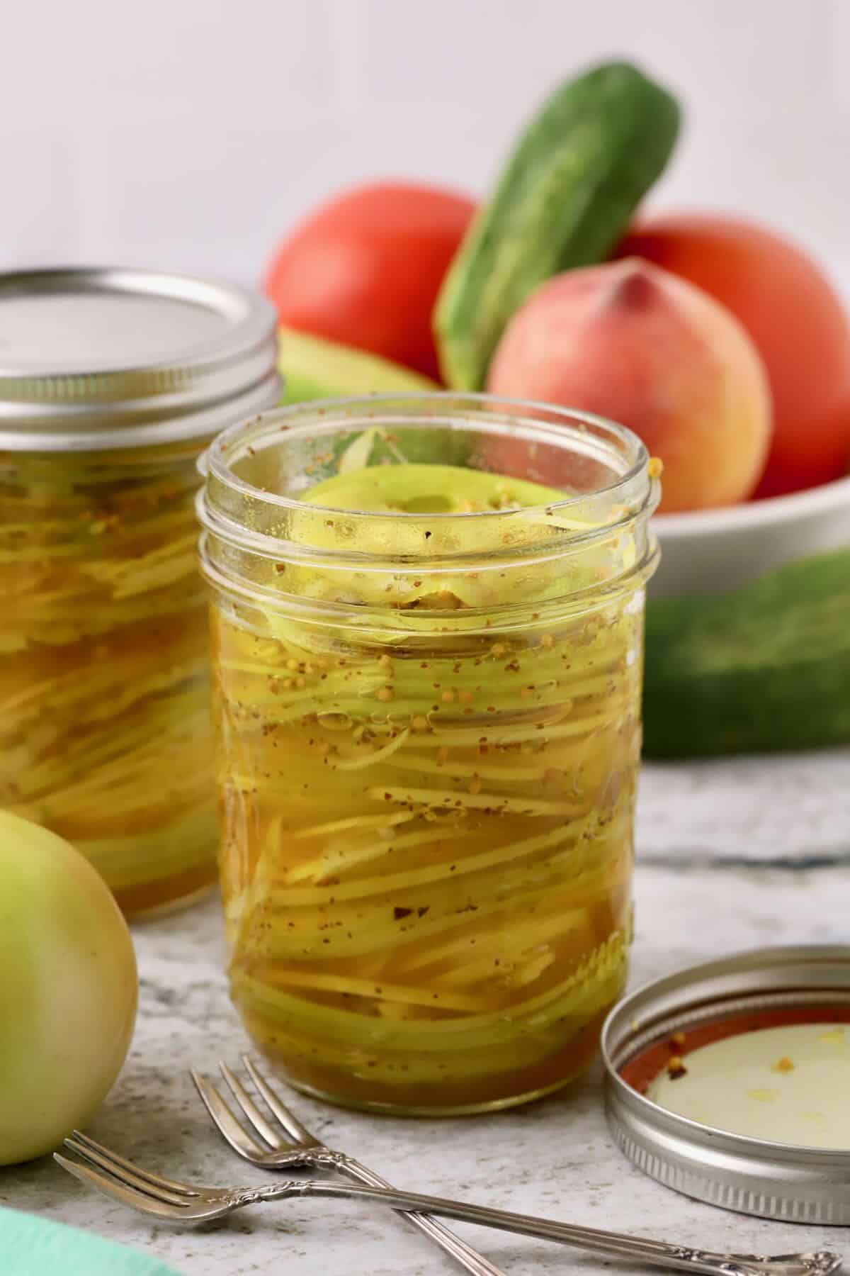 Jar of sweet pickled green tomatoes and Vidalia onions in refrigerator pickle brine