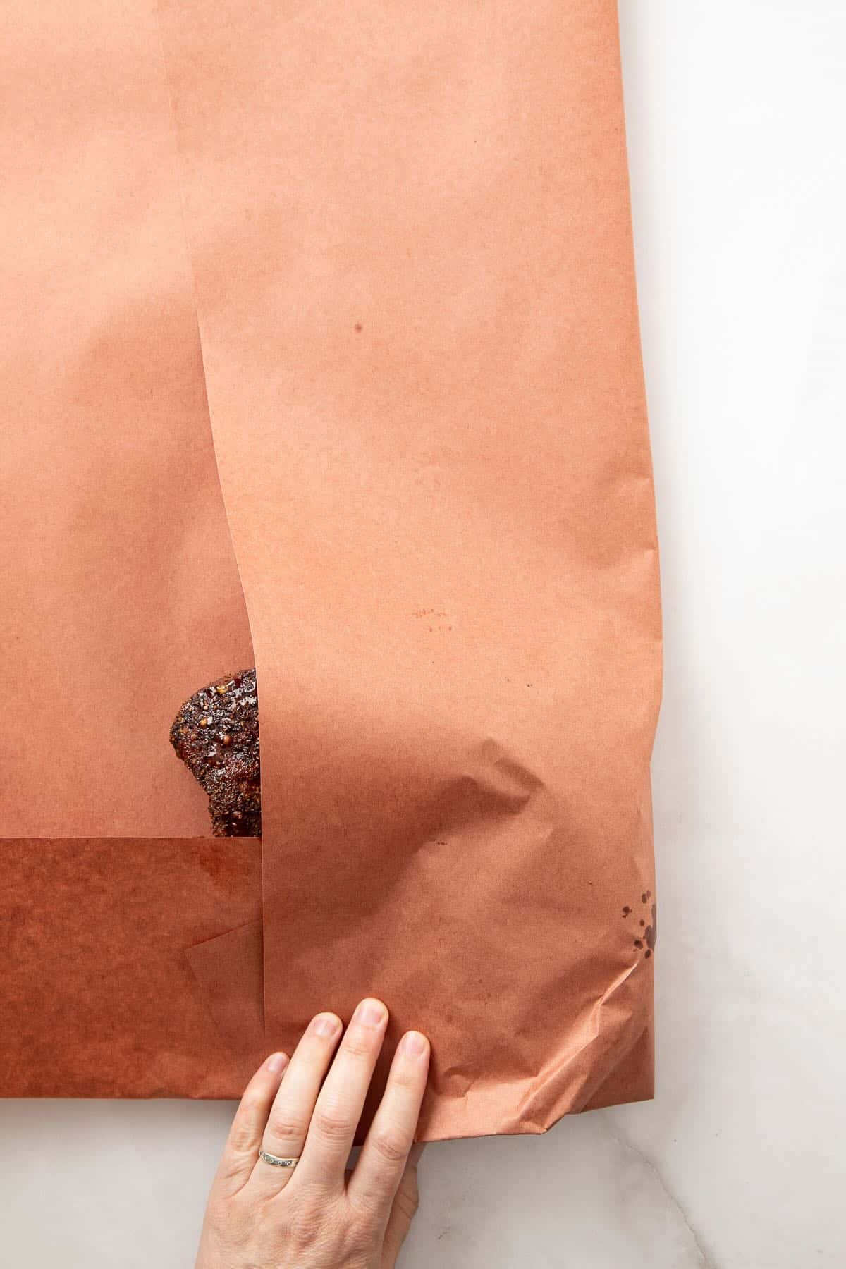 Wrapping a chuck roast that has been smoking in pink butcher paper.