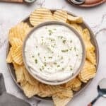 Beau Monde Dip in a bowl surrounded by ruffled potato chips.