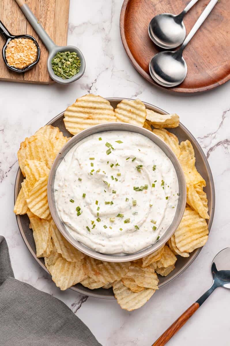 Beau Monde Dip in a bowl surrounded by potato chips.