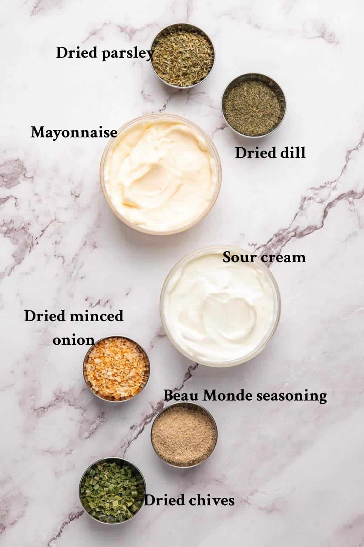 Beau monde dip ingredients includes mayonnaise, sour cream, dried minced onion, and dried parsley and chives.