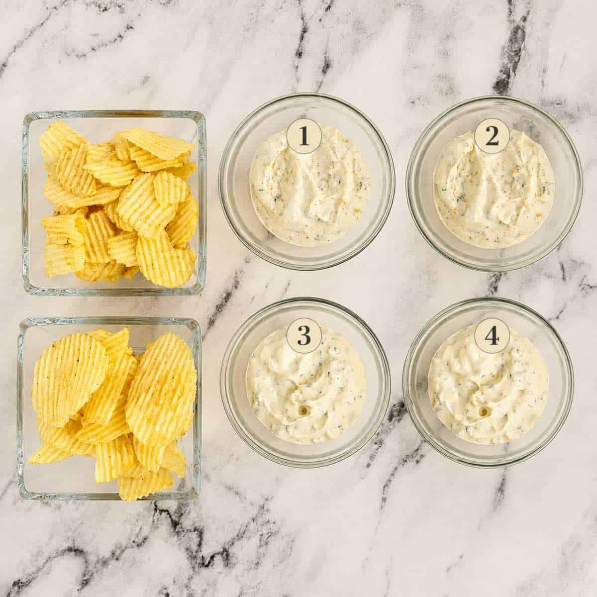 Four test bowls of Beau Monde Dip with potato chips.