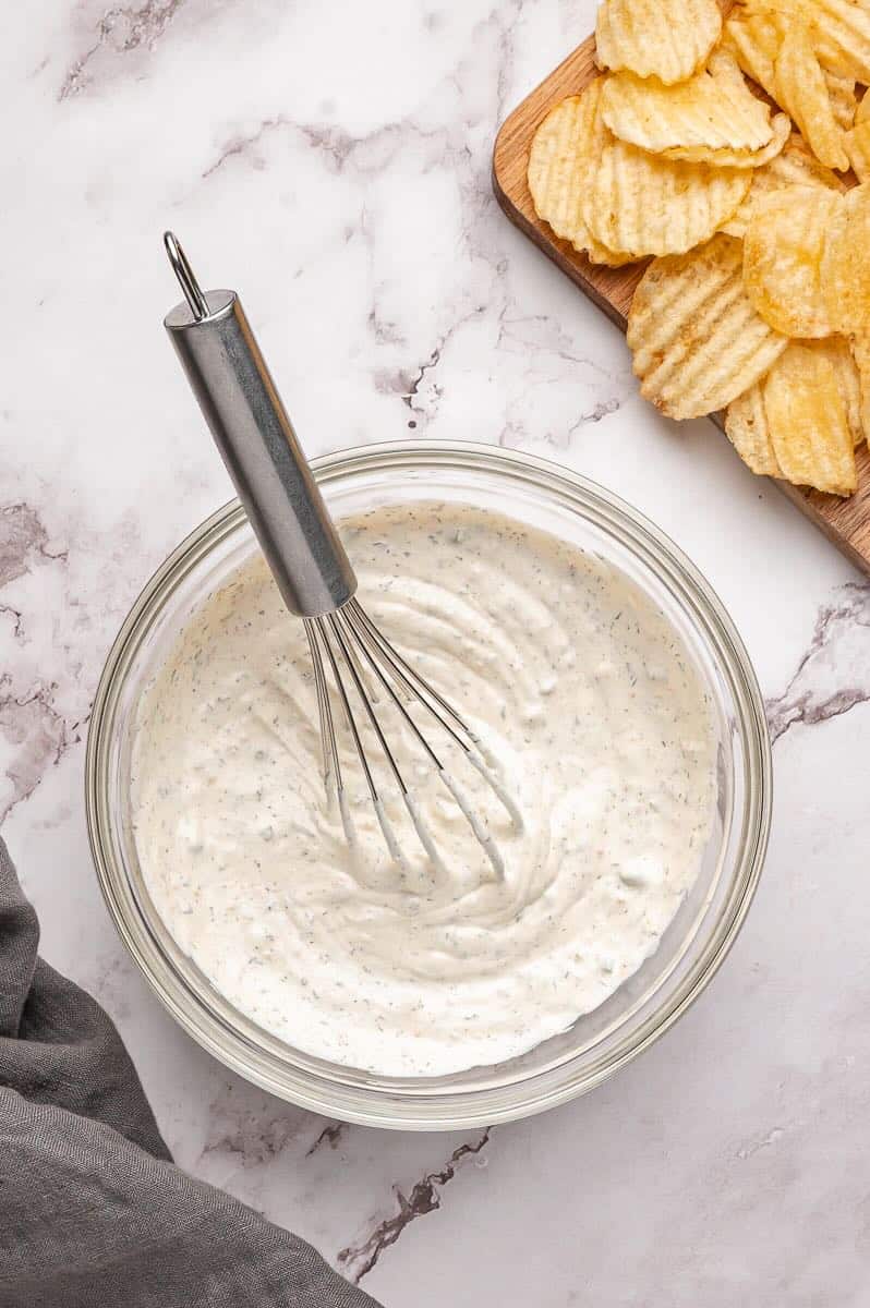All ingredients to make Beau Monde dip are whisked together in a bowl.