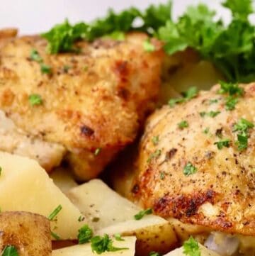 Crispy chicken thighs and potatoes cooked in a crock pot.