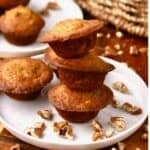 A stack of three banana nut mini muffins on a plate.