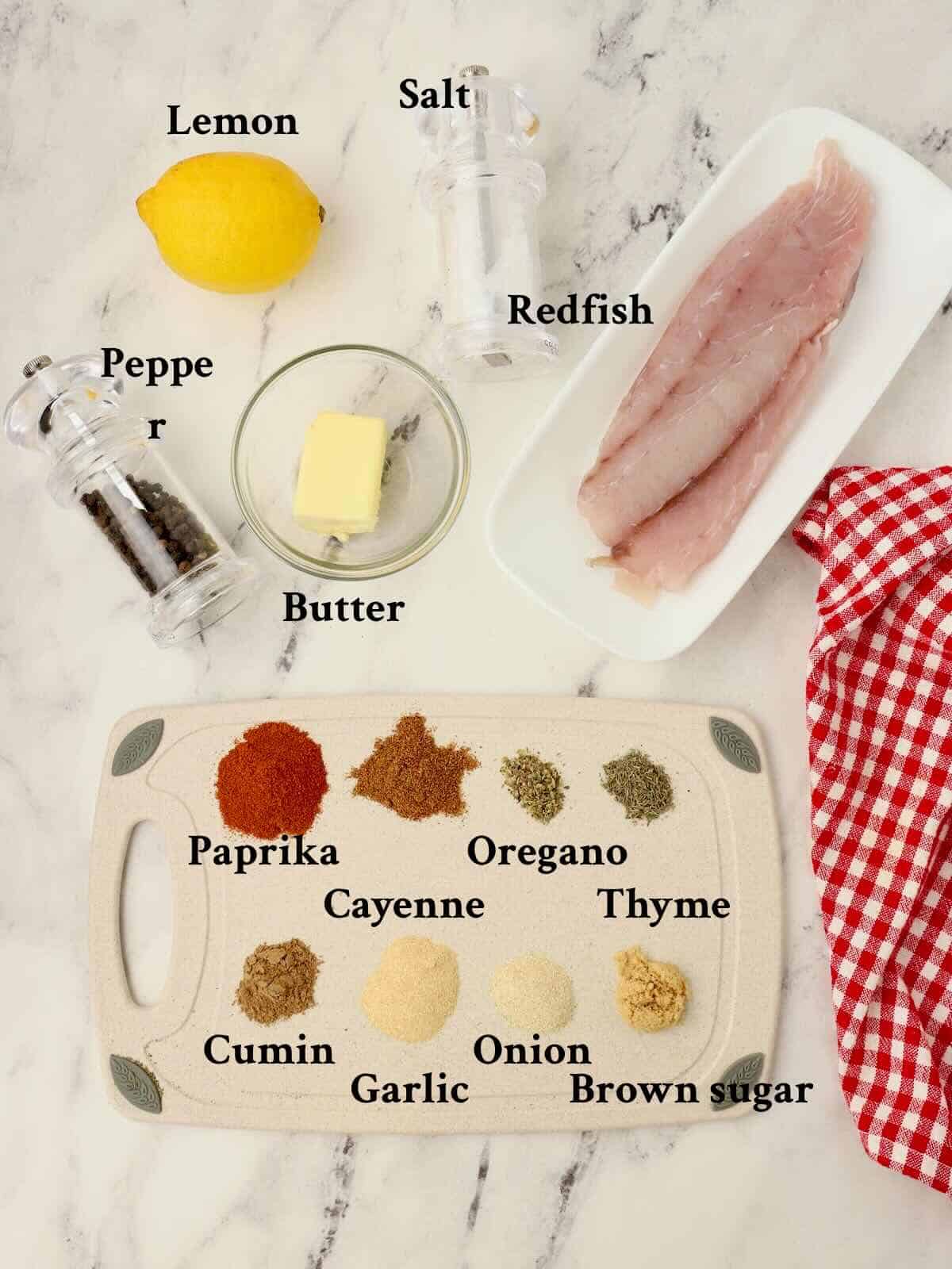 Ingredients to make blackened redfish, include redfish fillet, butter, and 8 different spices to make the seasoning.