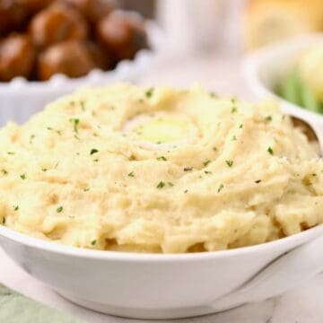 A large bowl of mashed potatoes cooked in a crock pot.