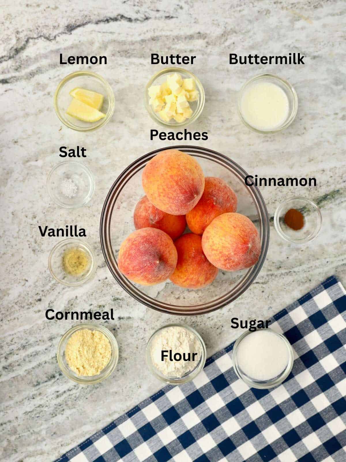 Ingredients for small batch peach cobbler include peaches, buttermilk, flour, cornmeal,and sugar.