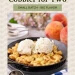 Small batch peach cornmeal cobbler for two topped with vanilla ice cream in a cast-iron skillet.