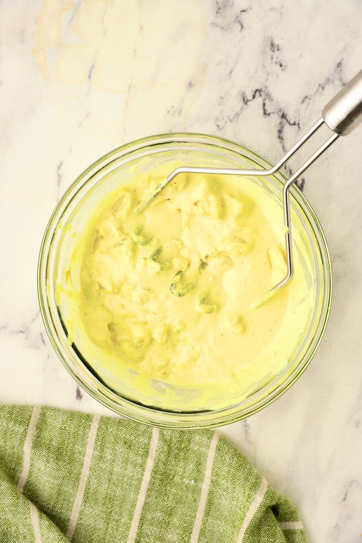 Use a potato masher to mash the potatoes 3-4 times.