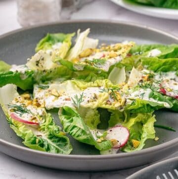 A serving of little gem salad with coconut ranch dressing on a salad plate.