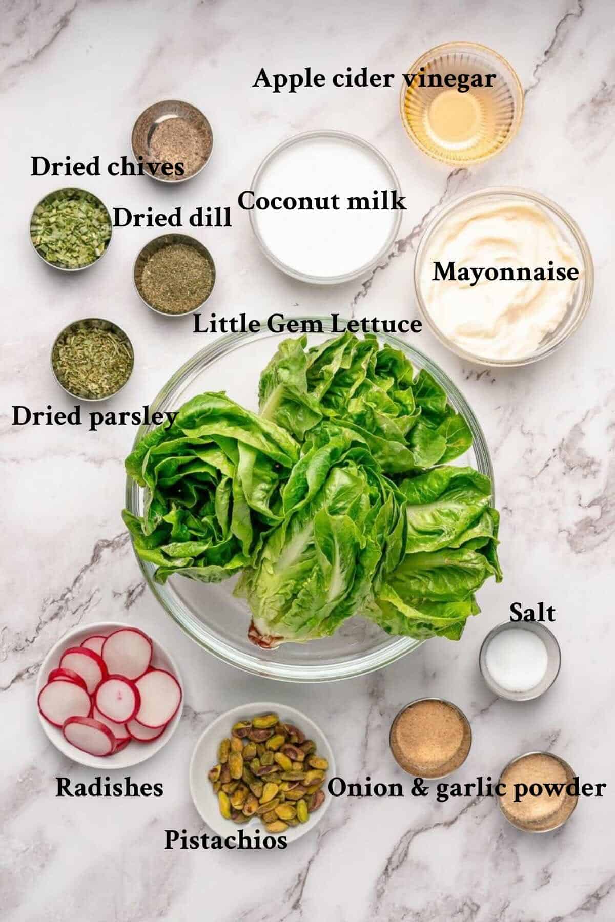 Ingredients to make little gem salad, and coconut ranch dressing arranged on a counter.