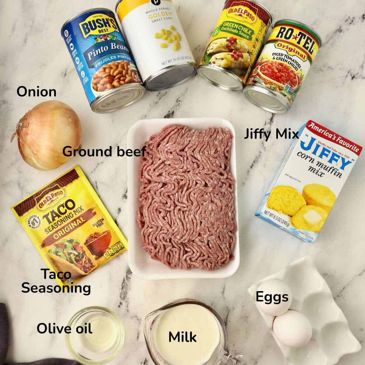 Ingredients to make Cowboy Cornbread Casserole on a counter includes Jiffy Corn Muffin Mix and ground beef.