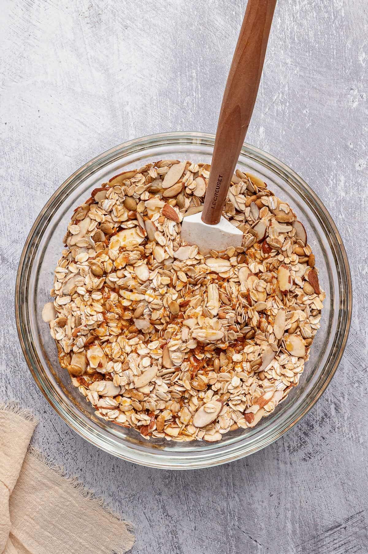 Combining the dry and wet ingredients to make granola.