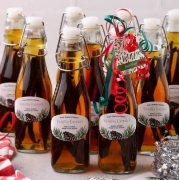 Ten bottles of vanilla extract made with vodka and bourbon, with labels ready to give as gifts.