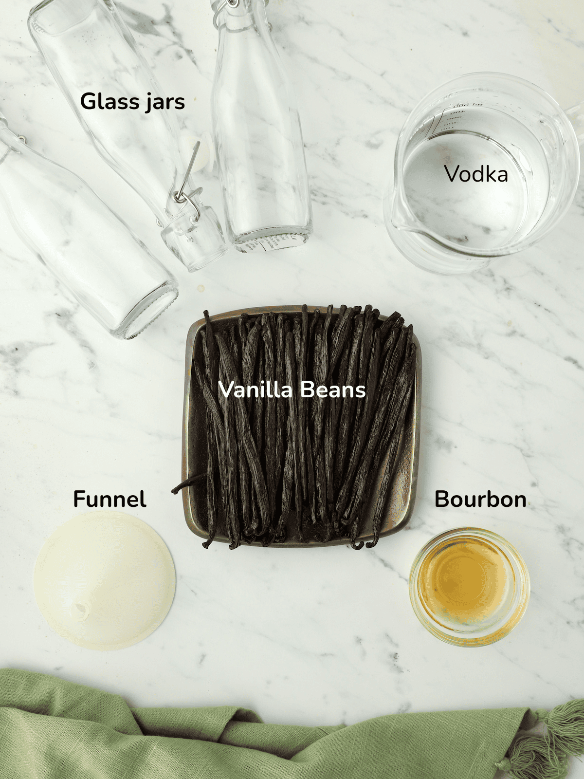 Ingredients and equipment to make homemade vanilla extract, vanilla beans, vodka, and bourbon.